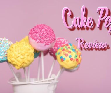 “a cake pop review logo with several pop cakes in a glass