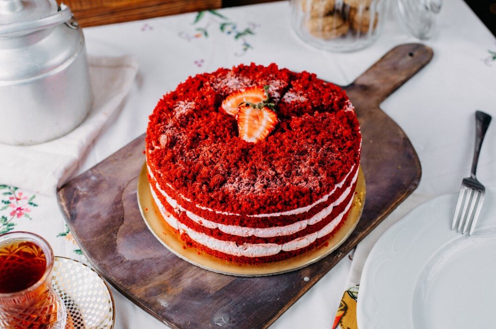 round red velvet cake on a wooden chopping board